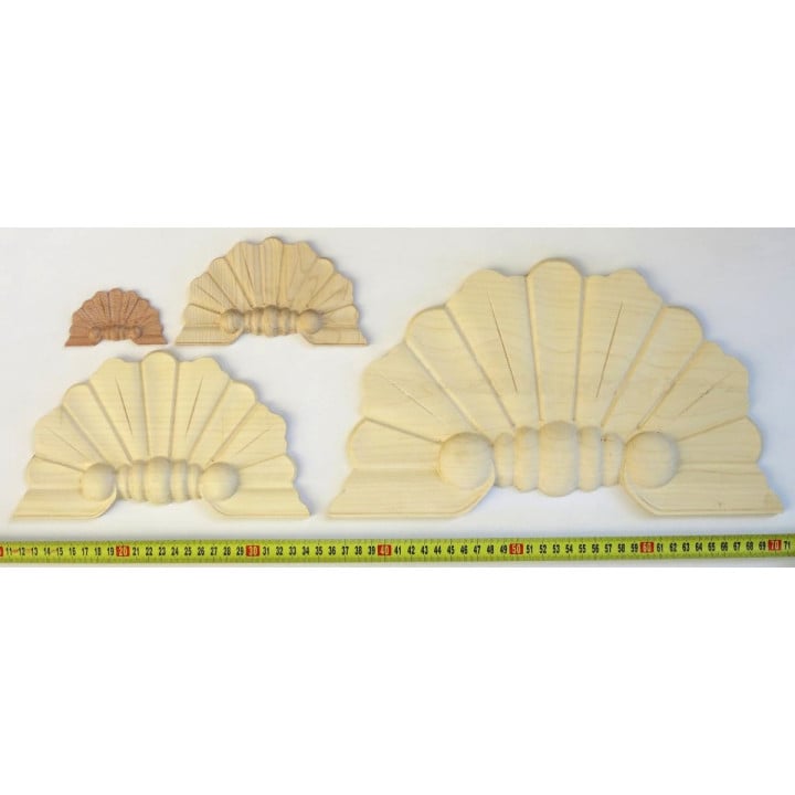 Wood applique resembling a peacock tail feathers