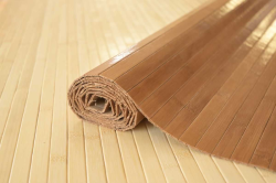 Väggskydd av brun bambu, bambupanel med baksida av textil. Kan limmas på väggen, men är också ett bra material för dörrfoder och mellanväggar.